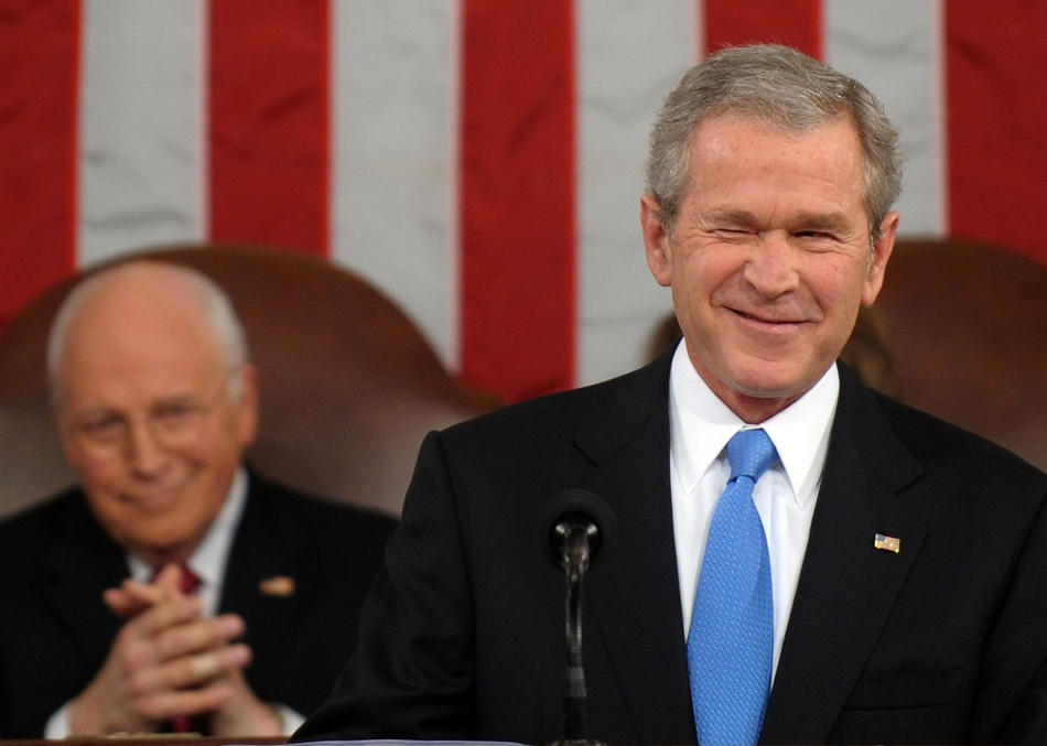 U.S. President George W. Bush winks while delivering his final State of the Union address as Vice President Dick Cheney (L) looks on at the U.S. Capitol January 28, 2008 in Washington, DC. Bush, in his last address, spoke on such topics as the uncertainty of the economy, the status of the war in Iraq, and immigration reform.  (Photo by Pool via Getty Images)